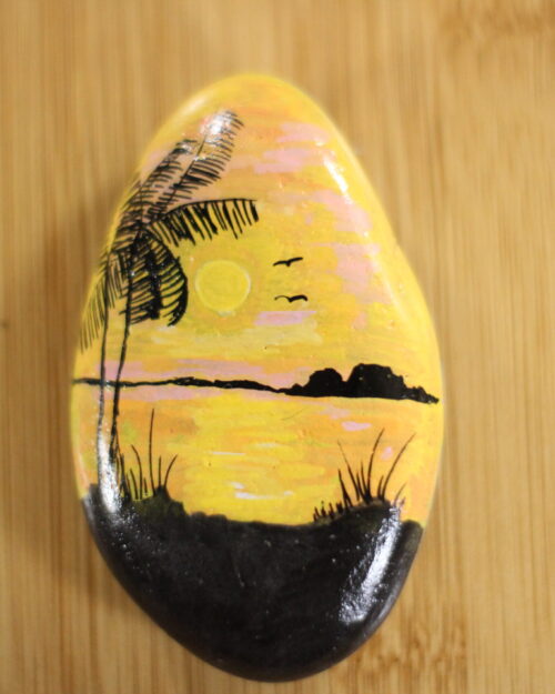 sunset painted onto a pebble