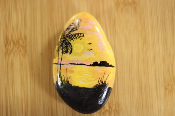 sunset painted onto a pebble