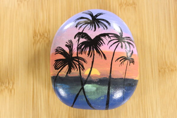 sunset with palm trees painted pebble
